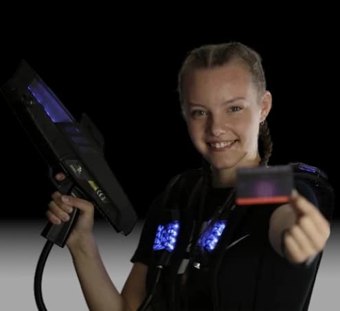 Model with MembershipCard.webp Delta Strike model holding a laser tag membership card